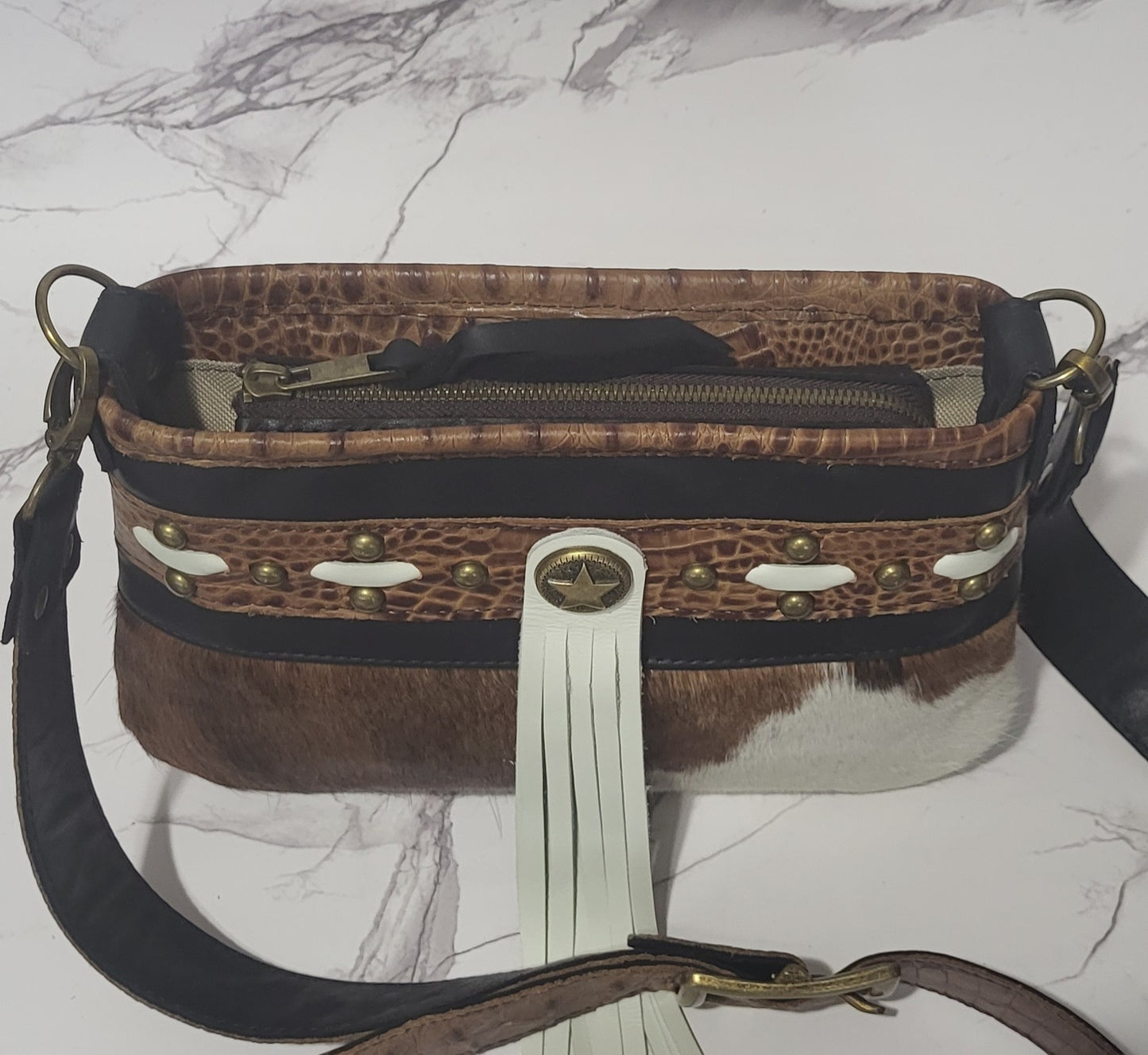 Western Belle in leather and brown/white cowhide.